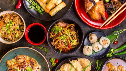 Assorted Chinese food set. Chinese noodles, fried rice, dumplings, peking duck, dim sum, spring rolls. Famous Chinese cuisine dishes on table. Top view. Chinese restaurant concept. Asian style banquet