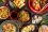Assorted Chinese food set. Chinese noodles, fried rice, dumplings, peking duck, dim sum, spring rolls. Famous Chinese cuisine dishes on table. Top view. Chinese restaurant concept. Asian style banquet